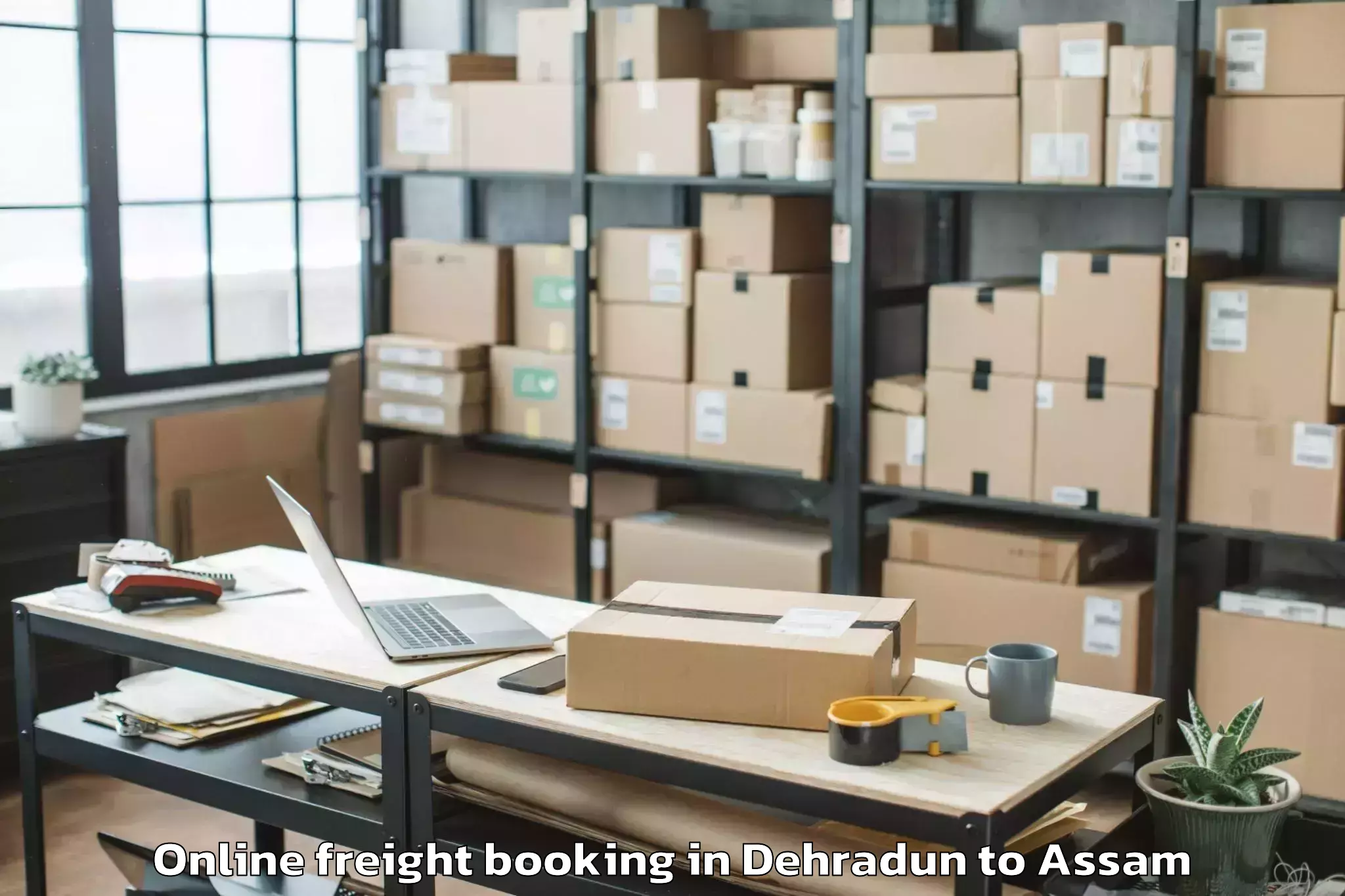 Reliable Dehradun to Kharupetia Online Freight Booking